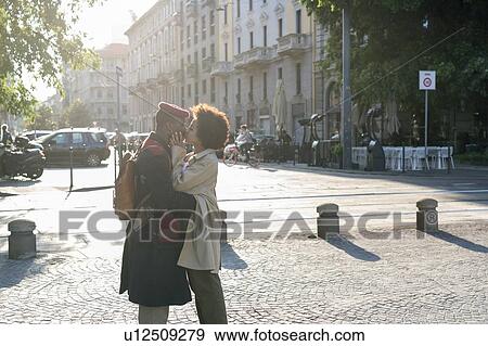 Couple kissing in street, Milan, Italy View Large Photo Image Stock Photo - Couple kissing in street, Milan, Italy. Fotosearch