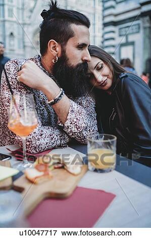 Stock Photo - Couple sharing loving moment in cafe. Fotosearch
