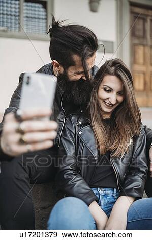 Couple taking selfie on steps View Large Photo Image Stock Photo - Couple taking selfie on steps. Fotosearch
