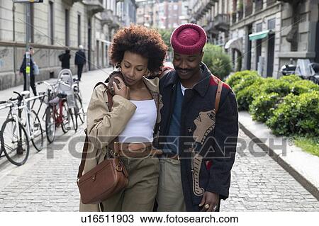 Couple walking in street, Milan, Italy View Large Photo Image Stock Image - Couple walking in street, Milan, Italy. Fotosearch