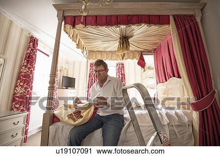 Curtain fitter fitting new pelmet to four poster bed View Large Photo Image Stock Image - Curtain fitter fitting new pelmet to four poster bed. Fotosearch