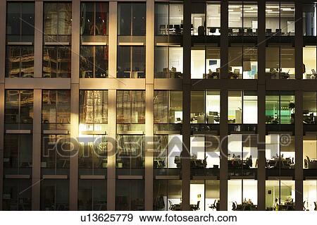 Stock Photo - Day to night image of an office block. Fotosearch