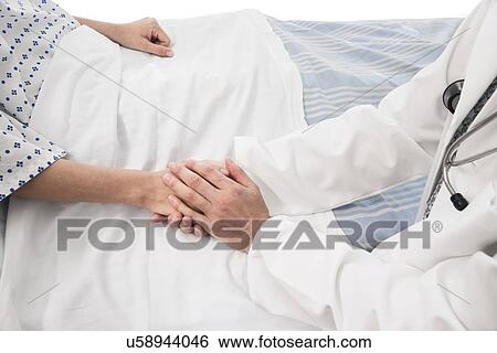 Doctor holding patient's hand View Large Photo Image Stock Photograph - Doctor holding patient's hand. Fotosearch