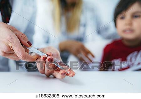 Doctor preparing a vaccine View Large Photo Image Stock Photograph - Doctor preparing a vaccine. Fotosearch