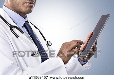 Doctor using digital tablet View Large Photo Image Stock Photo - Doctor using digital tablet. Fotosearch
