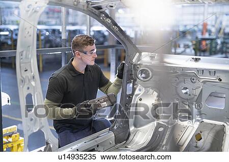 Engineer testing car body in car factory View Large Photo Image Stock Photography - Engineer testing car body in car factory. Fotosearch