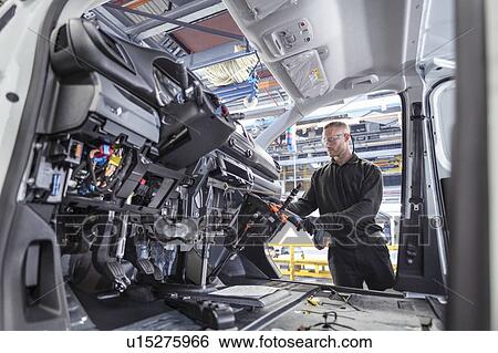 Engineer working on interior of van in car factory View Large Photo Image Stock Photograph - Engineer working on interior of van in car factory. Fotosearch