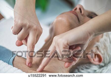 Stock Image - Facial marma therapy, ayurveda neck massage (kanth marma). Fotosearch