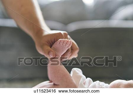 Father changing baby's diaper at home View Large Photo Image Stock Photograph - Father changing baby's diaper at home. Fotosearch