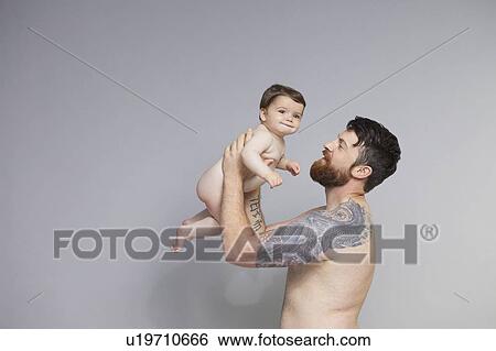 Stock Photograph - Father lifting baby. Fotosearch