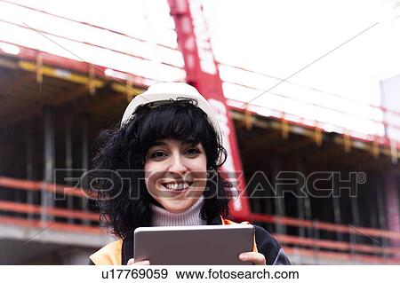 Female surveyor using digital tablet on construction site, portrait View Large Photo Image Stock Photo - Female surveyor using digital tablet on construction site, portrait. Fotosearch