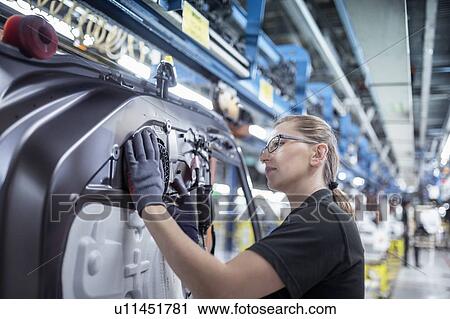 Female worker assembling car doors on production line in a car factory View Large Photo Image Stock Image - Female worker assembling car doors on production line in a car factory. Fotosearch