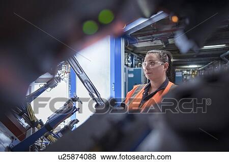 Female worker assembling vehicle roofs in car factory View Large Photo Image Stock Photo - Female worker assembling vehicle roofs in car factory. Fotosearch