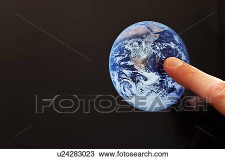 Stock Image - Finger pointing at the Earth. Fotosearch