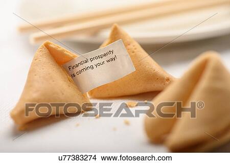 Picture - Fortune cookies by chopsticks on plate. Fotosearch