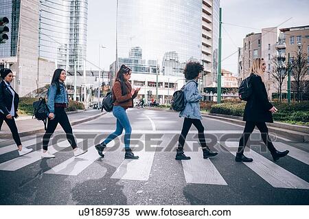 Friends crossing road on zebra crossing View Large Photo Image Stock Photography - Friends crossing road on zebra crossing. Fotosearch