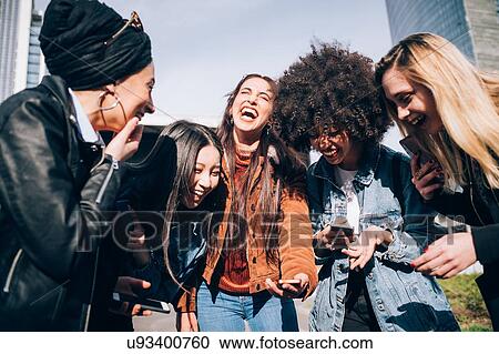 Friends laughing in street, Milan, Italy View Large Photo Image Stock Image - Friends laughing in street, Milan, Italy. Fotosearch