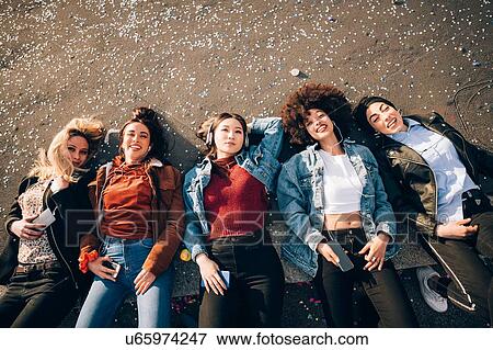 Friends lying on kerb, Milan, Italy View Large Photo Image Stock Photo - Friends lying on kerb, Milan, Italy. Fotosearch