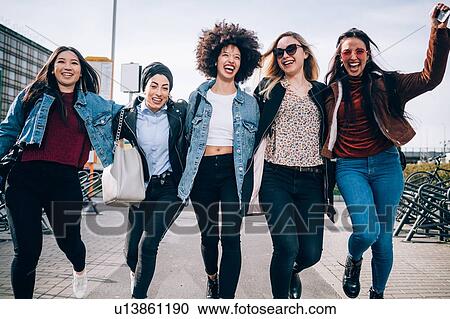 Friends running in street, Milan, Italy View Large Photo Image Stock Image - Friends running in street, Milan, Italy. Fotosearch