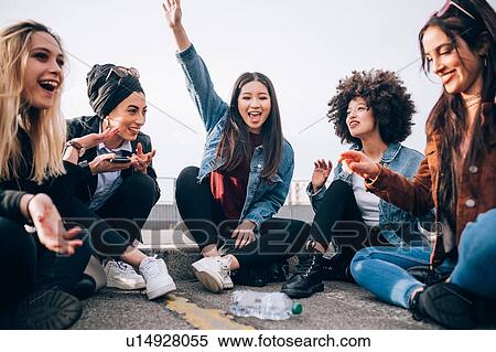 Friends sitting on kerb, Milan, Italy View Large Photo Image Stock Photography - Friends sitting on kerb, Milan, Italy. Fotosearch