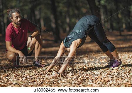 Stock Photography - Friends stretching after training in the park. Fotosearch