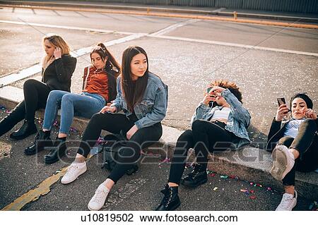 Friends together on kerb, Milan, Italy View Large Photo Image Stock Image - Friends together on kerb, Milan, Italy. Fotosearch
