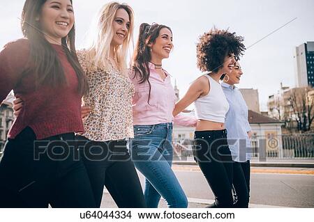 Picture - Friends walking in street, Milan, Italy. Fotosearch