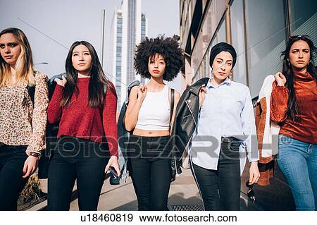 Stock Photo - Friends walking in street, Milan, Italy. Fotosearch