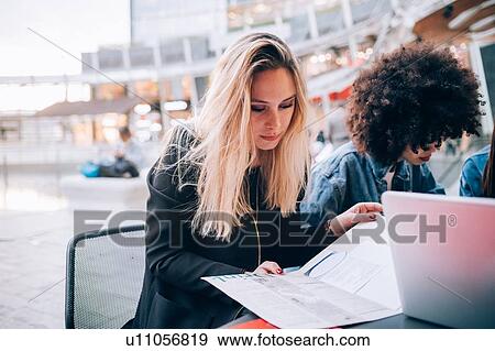 Friends working on project at outdoor cafe, Milan, Italy View Large Photo Image Stock Photo - Friends working on project at outdoor cafe, Milan, Italy. Fotosearch