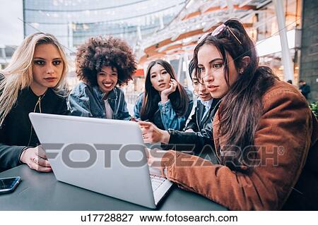 Friends working on project at outdoor cafe, Milan, Italy View Large Photo Image Stock Photo - Friends working on project at outdoor cafe, Milan, Italy. Fotosearch