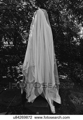 Stock Image - Ghost by trees. Fotosearch