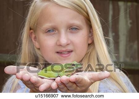 Girl holding frog View Large Photo Image Stock Photo - Girl holding frog. Fotosearch