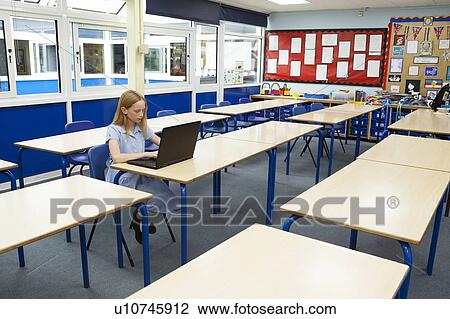 Stock Image - Girl in classroom. Fotosearch