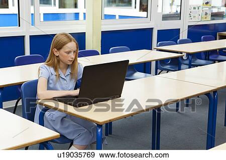 Stock Photo - Girl in classroom. Fotosearch