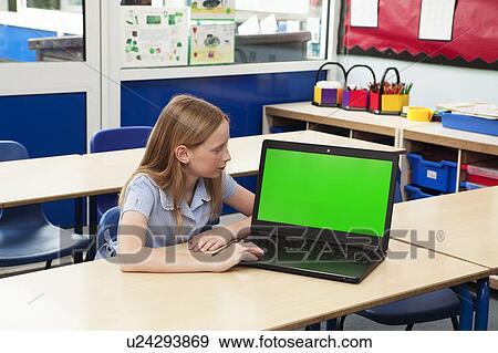 Girl in classroom with laptop View Large Photo Image Stock Photo - Girl in classroom with laptop. Fotosearch