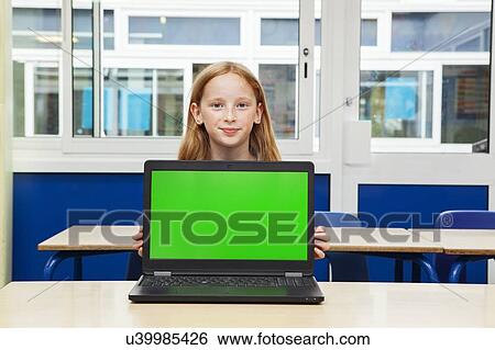 Stock Photograph - Girl in classroom with laptop. Fotosearch