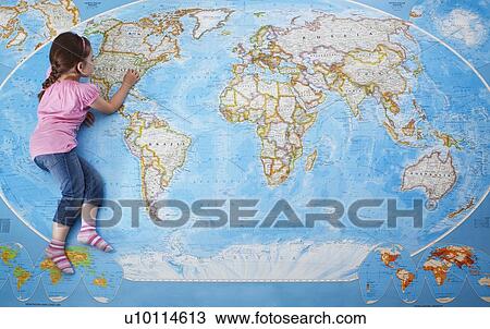 Girl looking at map of the world View Large Photo Image Stock Image - Girl looking at map of the world. Fotosearch