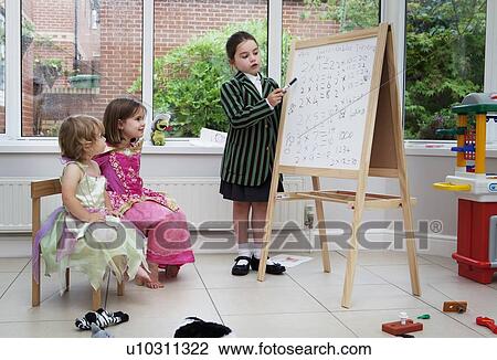 Stock Image - Girl playing teacher. Fotosearch