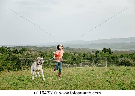 Girl running with labrador dog in scenic field landscape, Citta della Pieve, Umbria, Italy View Large Photo Image Stock Image - Girl running with labrador dog in scenic field landscape, Citta della Pieve, Umbria, Italy. Fotosearch