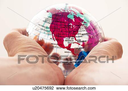 Stock Image - Globe held in hands. Fotosearch