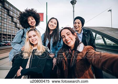 Group of friends laughing in street, Milan, Italy View Large Photo Image Stock Photography - Group of friends laughing in street, Milan, Italy. Fotosearch