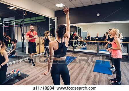 Group of women training in gym, questioning male trainer View Large Photo Image Picture - Group of women training in gym, questioning male trainer. Fotosearch