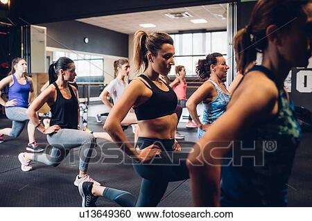 Group of women training in gym, stretching with hands on hips View Large Photo Image Stock Image - Group of women training in gym, stretching with hands on hips. Fotosearch