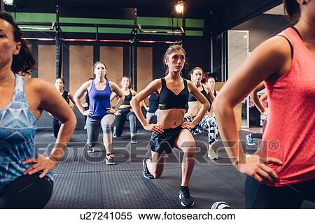 Group of women training in gym, with hands on hips and legs outstretched, front view View Large Photo Image Stock Photography - Group of women training in gym, with hands on hips and legs outstretched, front view. Fotosearch