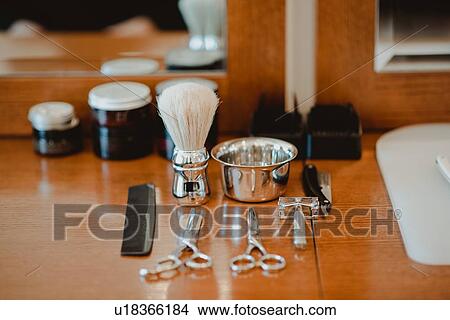 Picture - Hairdressing and shaving tools on table. Fotosearch