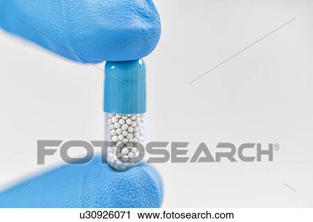 Hand holding pill View Large Photo Image Stock Image - Hand holding pill. Fotosearch