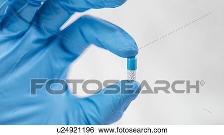 Hand holding pill View Large Photo Image Stock Photograph - Hand holding pill. Fotosearch