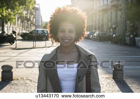 Stock Image - Happy woman with afro hairstyle, Milan, Italy. Fotosearch