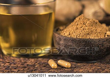 Stock Image - Herbal ginger supplement capsules, ginger powder and tea. Fotosearch