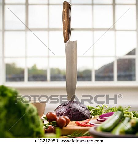 Kitchen knife stuck in red cabbage on kitchen counter, still life View Large Photo Image Stock Image - Kitchen knife stuck in red cabbage on kitchen counter, still life. Fotosearch